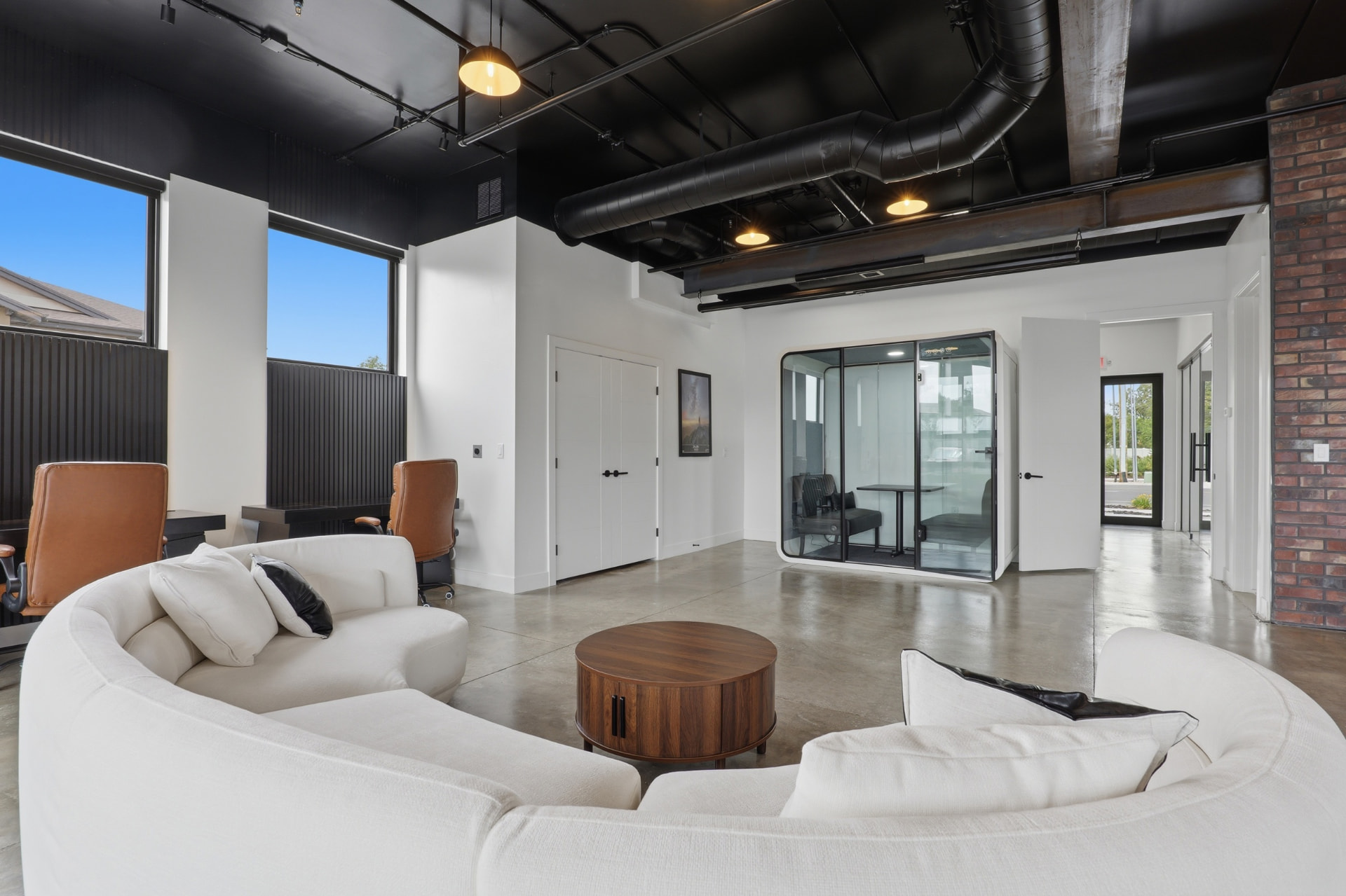 Kairos headquarters lobby with curved sofa and glass meeting pod