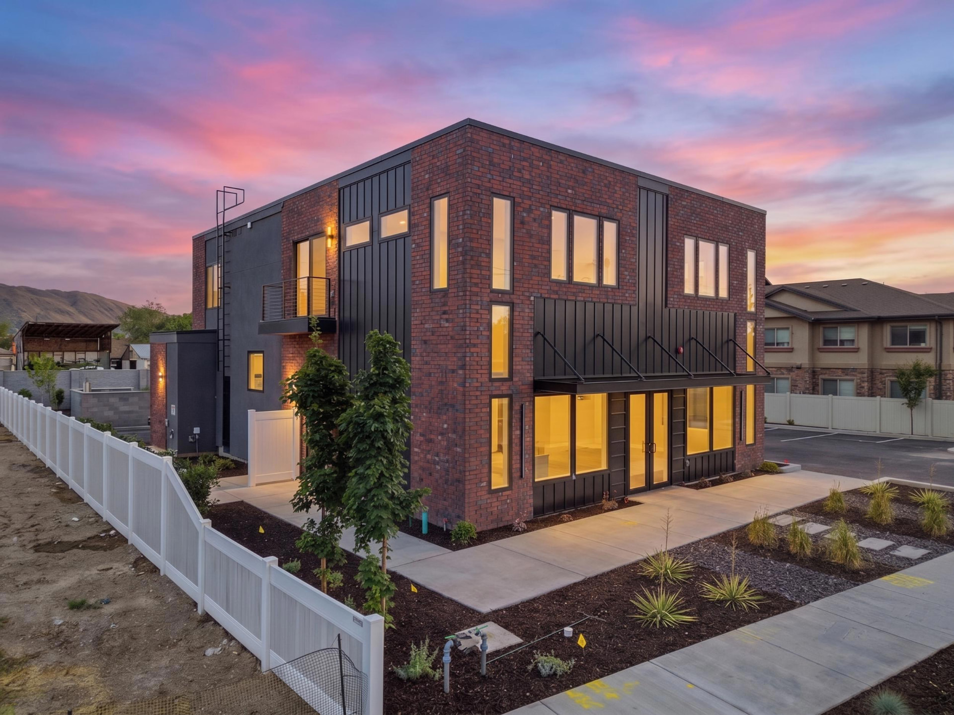 Kairos headquarters brick and black steel building at sunset